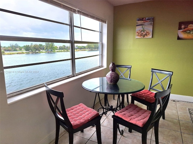 tiled dining space featuring a water view