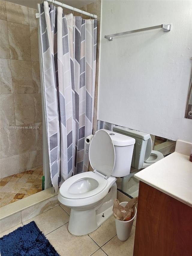 bathroom featuring a shower with curtain, vanity, toilet, and tile patterned floors