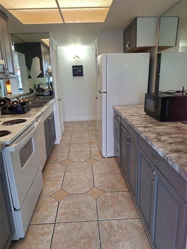 kitchen featuring gray cabinets, sink, and white appliances