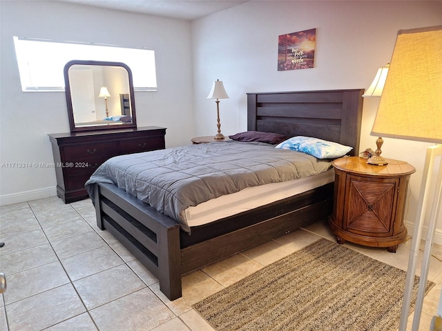 tiled bedroom with multiple windows