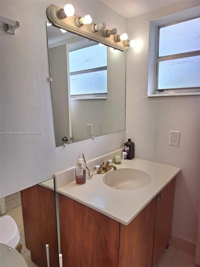 bathroom with tile patterned floors, vanity, and toilet