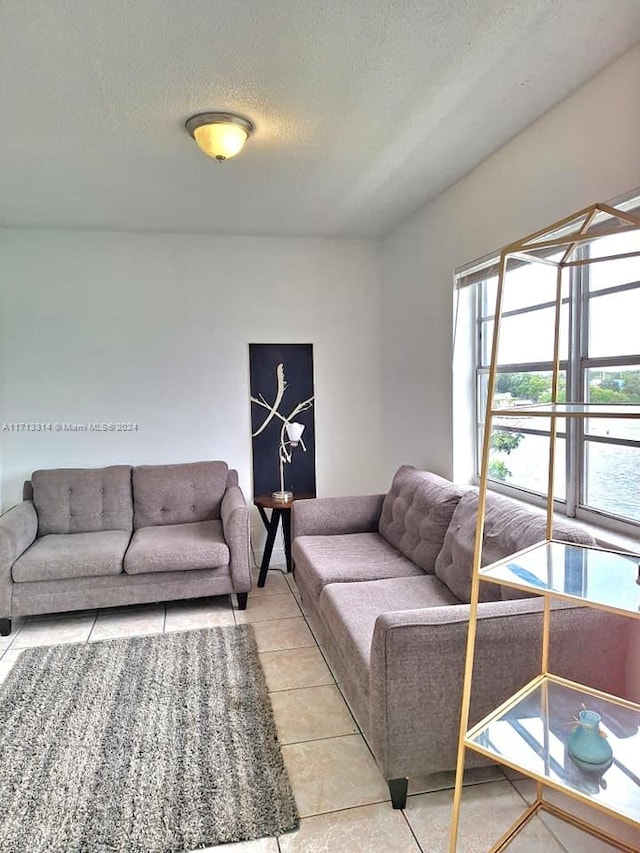 tiled living room with a textured ceiling