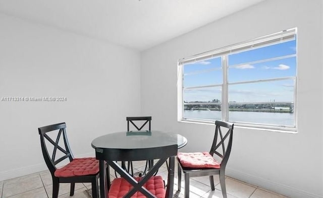 tiled dining room with a water view