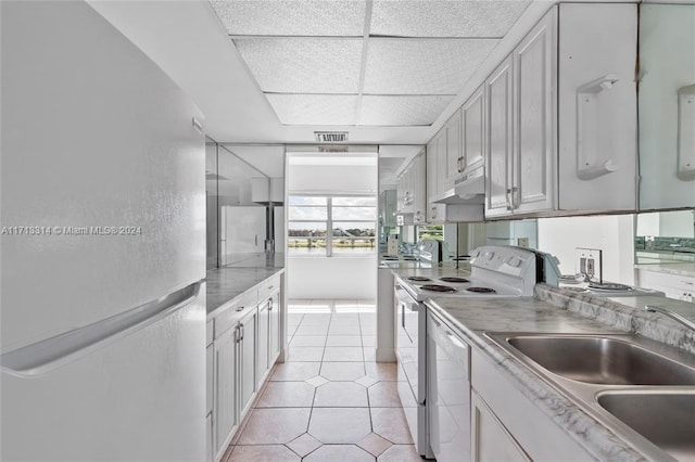 kitchen featuring white cabinetry, white appliances, and sink