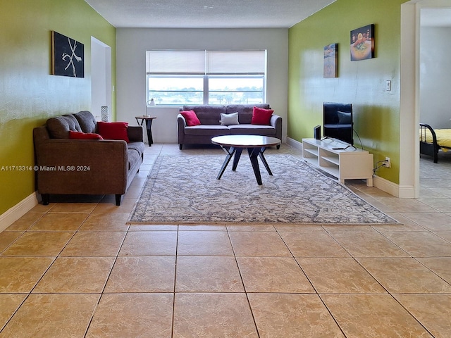 living room with light tile patterned floors and a textured ceiling