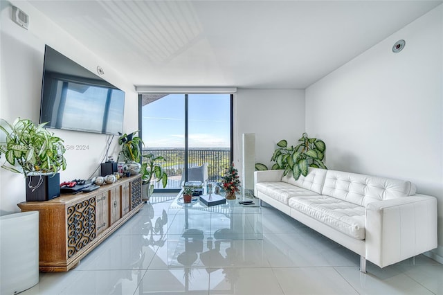 living room featuring tile patterned flooring and floor to ceiling windows