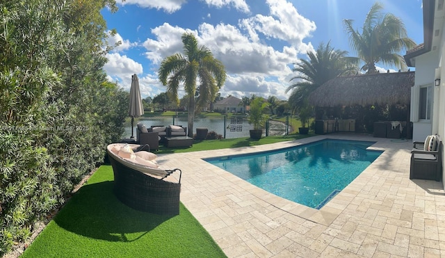 view of pool with a fenced in pool, a water view, a patio area, fence private yard, and an outdoor living space