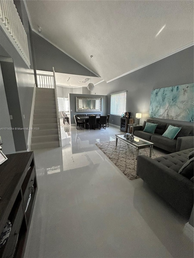 living area featuring a textured ceiling, high vaulted ceiling, ornamental molding, and stairway