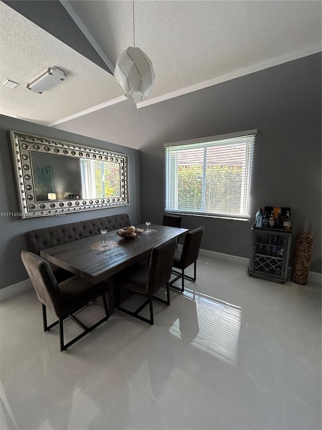 dining area with vaulted ceiling, a textured ceiling, and baseboards