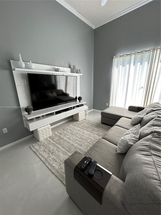 living area with crown molding, concrete flooring, and baseboards