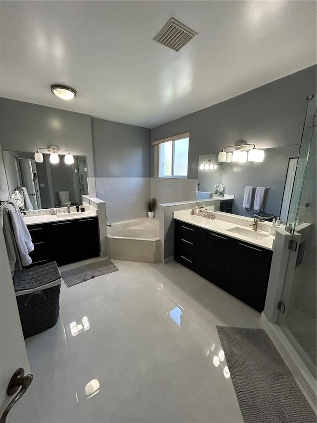 full bathroom with a stall shower, visible vents, vanity, and a bath