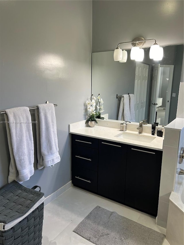 bathroom featuring baseboards and vanity