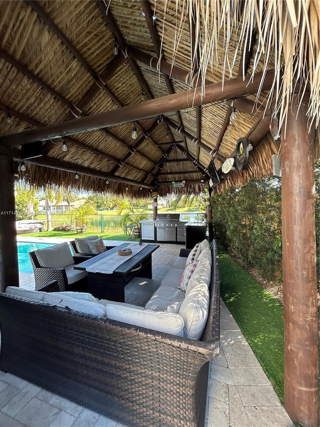 view of patio / terrace with an outdoor living space, an outdoor kitchen, and a gazebo