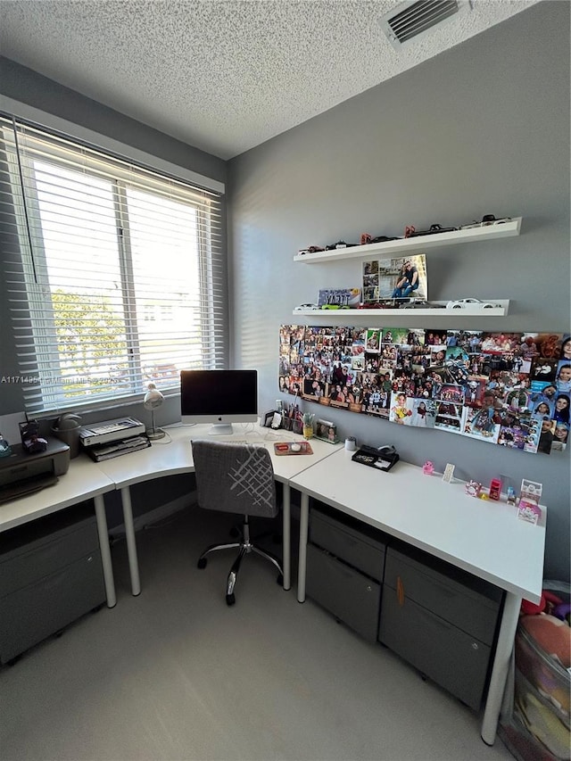 home office featuring visible vents and a textured ceiling