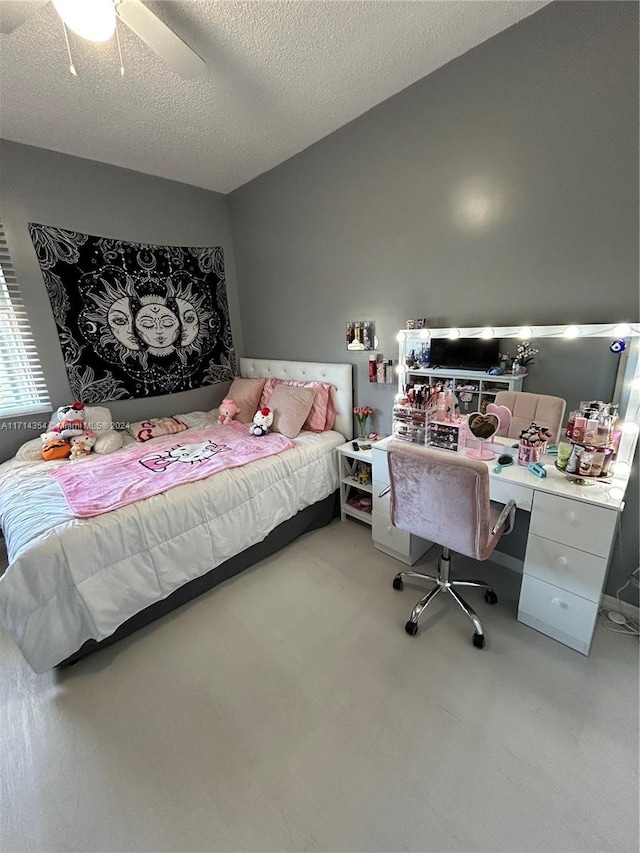 bedroom featuring ceiling fan, built in desk, and a textured ceiling