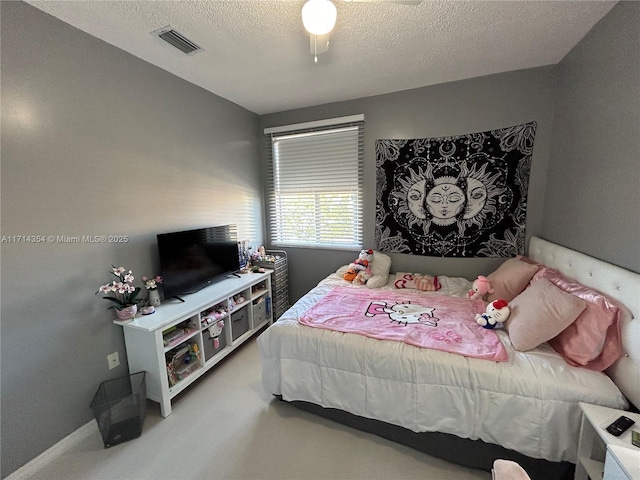 bedroom with baseboards, carpet, visible vents, and a textured ceiling