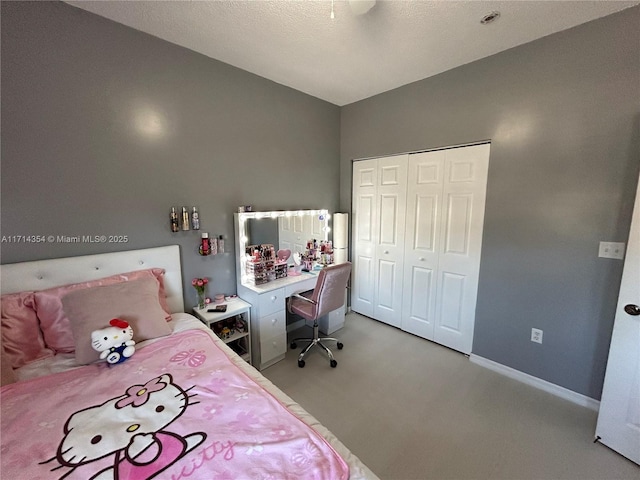 bedroom featuring a closet, light colored carpet, and baseboards