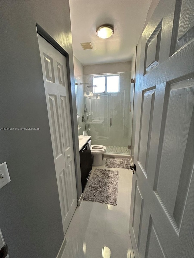 full bath featuring a closet, visible vents, toilet, a stall shower, and vanity