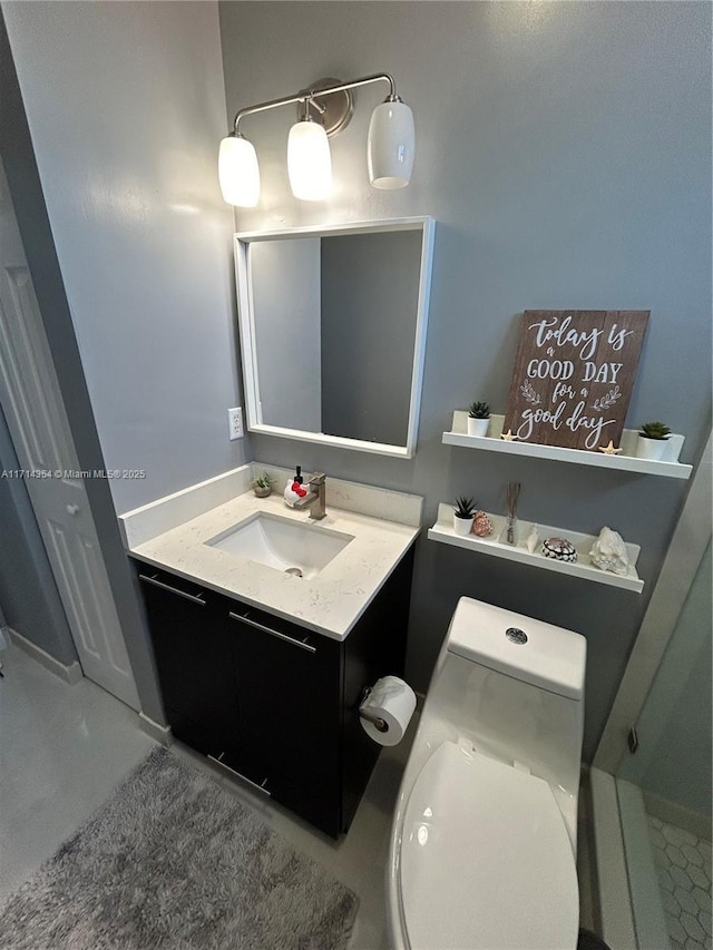 bathroom featuring vanity and toilet