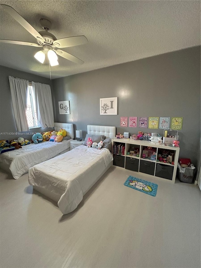 bedroom with ceiling fan and a textured ceiling