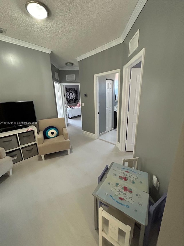 interior space with light carpet, ornamental molding, a textured ceiling, and visible vents