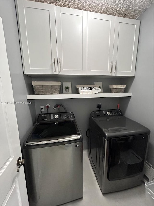 clothes washing area with cabinet space and washing machine and clothes dryer