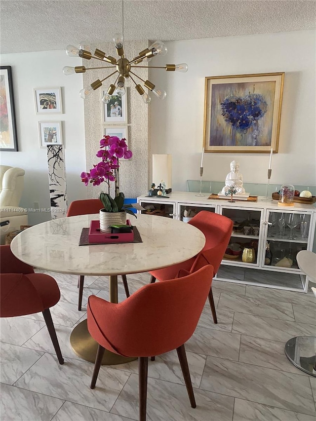 dining room featuring a chandelier and a textured ceiling