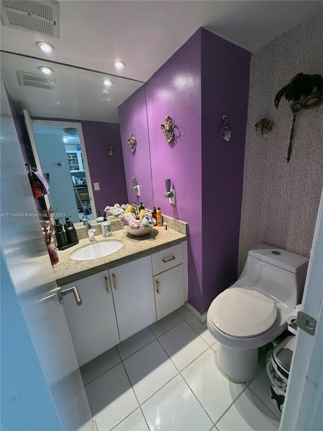 bathroom featuring tile patterned flooring, vanity, and toilet