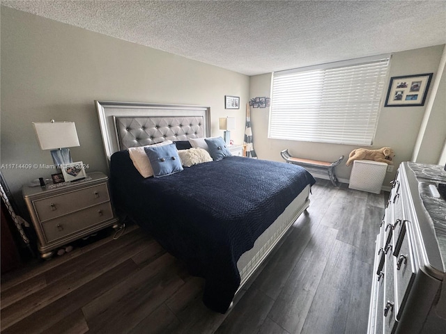 bedroom with a textured ceiling and dark wood-type flooring