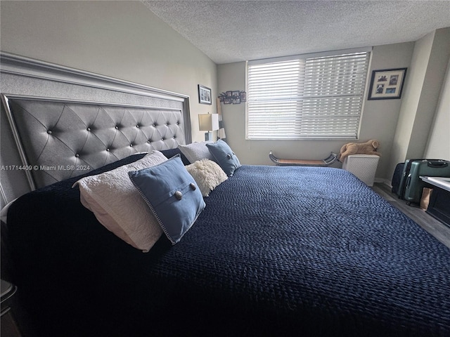 bedroom featuring wood-type flooring and a textured ceiling