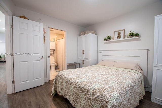 bedroom with ensuite bathroom and dark hardwood / wood-style floors