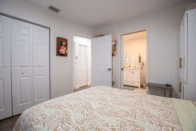 bedroom featuring hardwood / wood-style flooring and ensuite bathroom