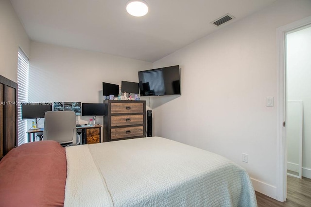 bedroom with wood-type flooring