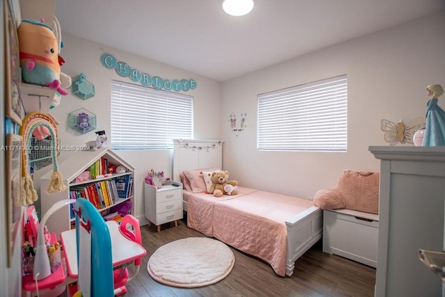 bedroom with dark hardwood / wood-style floors