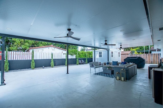 view of patio / terrace with outdoor lounge area, ceiling fan, a shed, and a grill