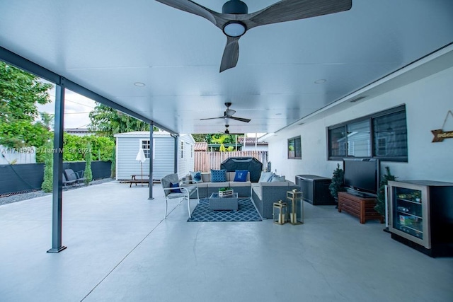 view of patio featuring a shed, ceiling fan, and an outdoor hangout area