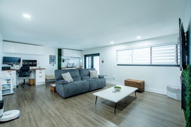 living room featuring built in desk and light wood-type flooring