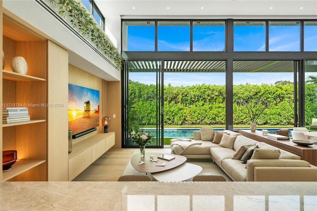 living room with plenty of natural light and a high ceiling