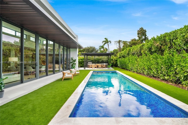 view of pool with a yard