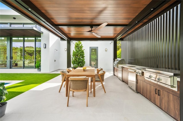 view of patio with a grill, ceiling fan, and exterior kitchen