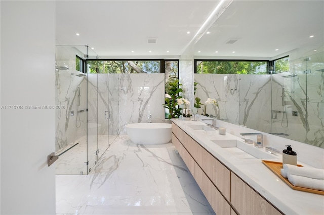 bathroom featuring independent shower and bath and vanity