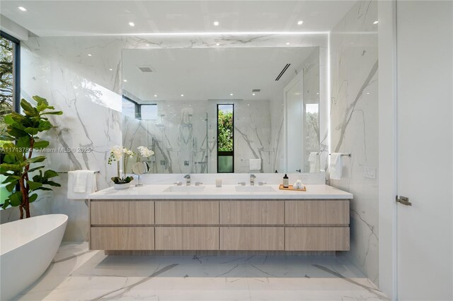 bathroom with vanity, tile walls, and a washtub