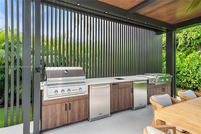 view of patio with area for grilling and a grill