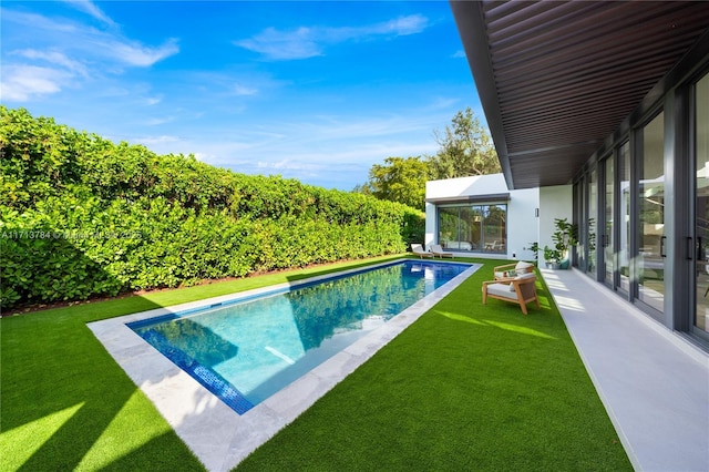 view of pool featuring a yard