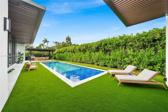 view of swimming pool featuring an outdoor hangout area and a lawn