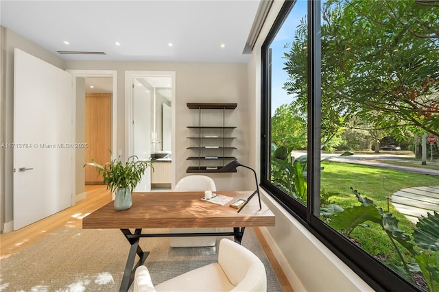 office area with light hardwood / wood-style floors