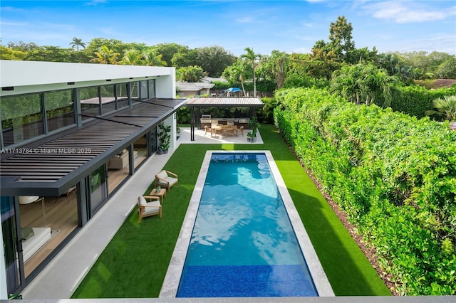 view of pool with a yard and an outdoor bar