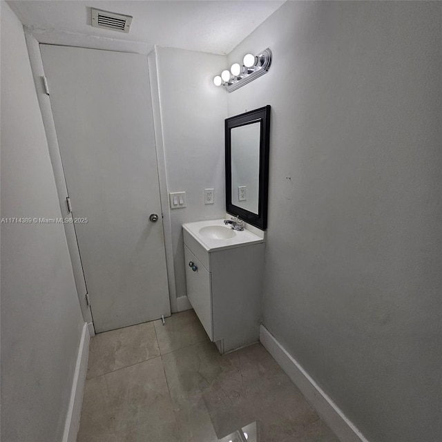 bathroom with baseboards, visible vents, and vanity