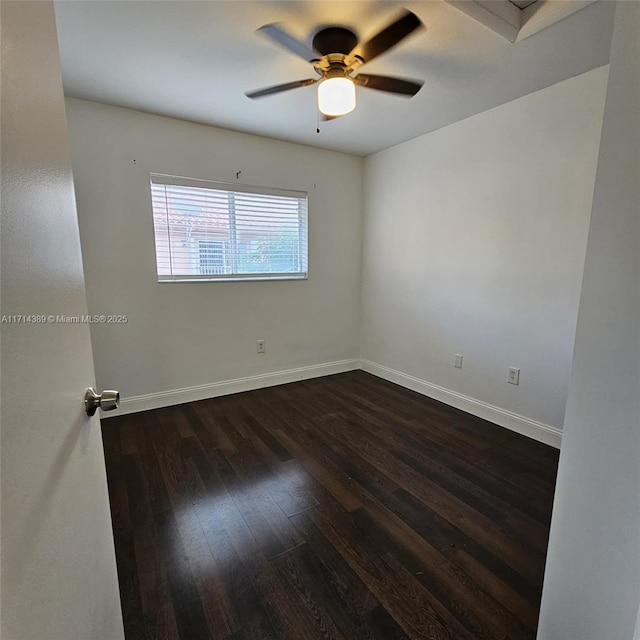 unfurnished room featuring dark wood-style floors, baseboards, and a ceiling fan