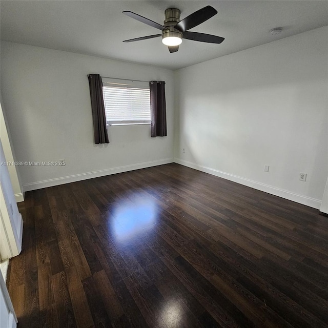 unfurnished room featuring ceiling fan, wood finished floors, and baseboards